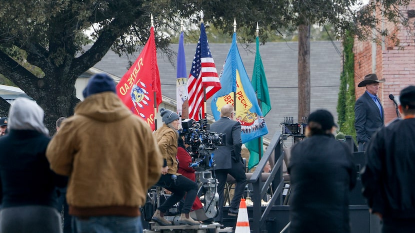 People watch as crew members work during filming for “Yellowstone” in the town square of...