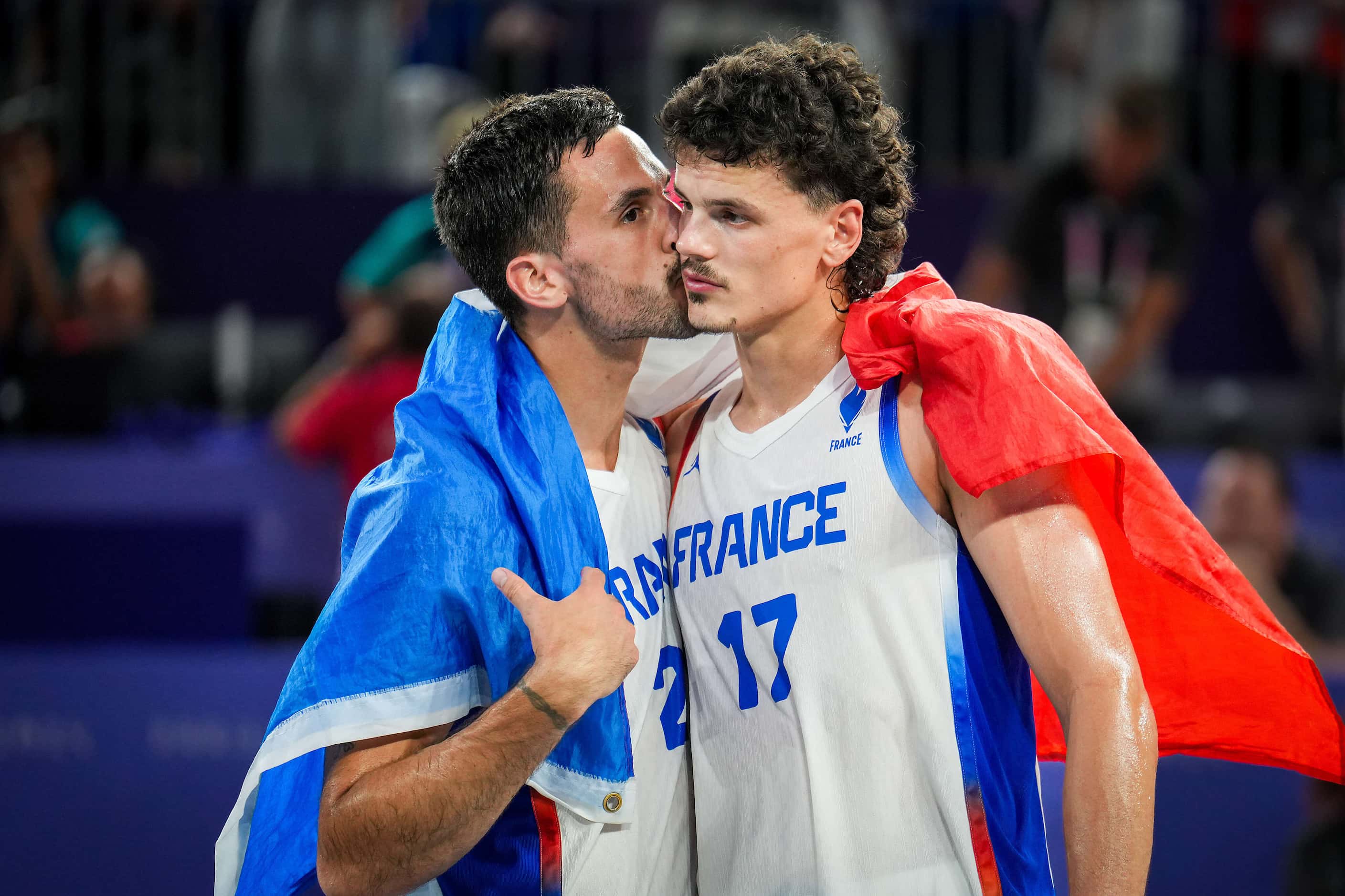 Jules Rambaut (17) of France gets a kiss from teammate Franck Seguela (21) after a loss to...