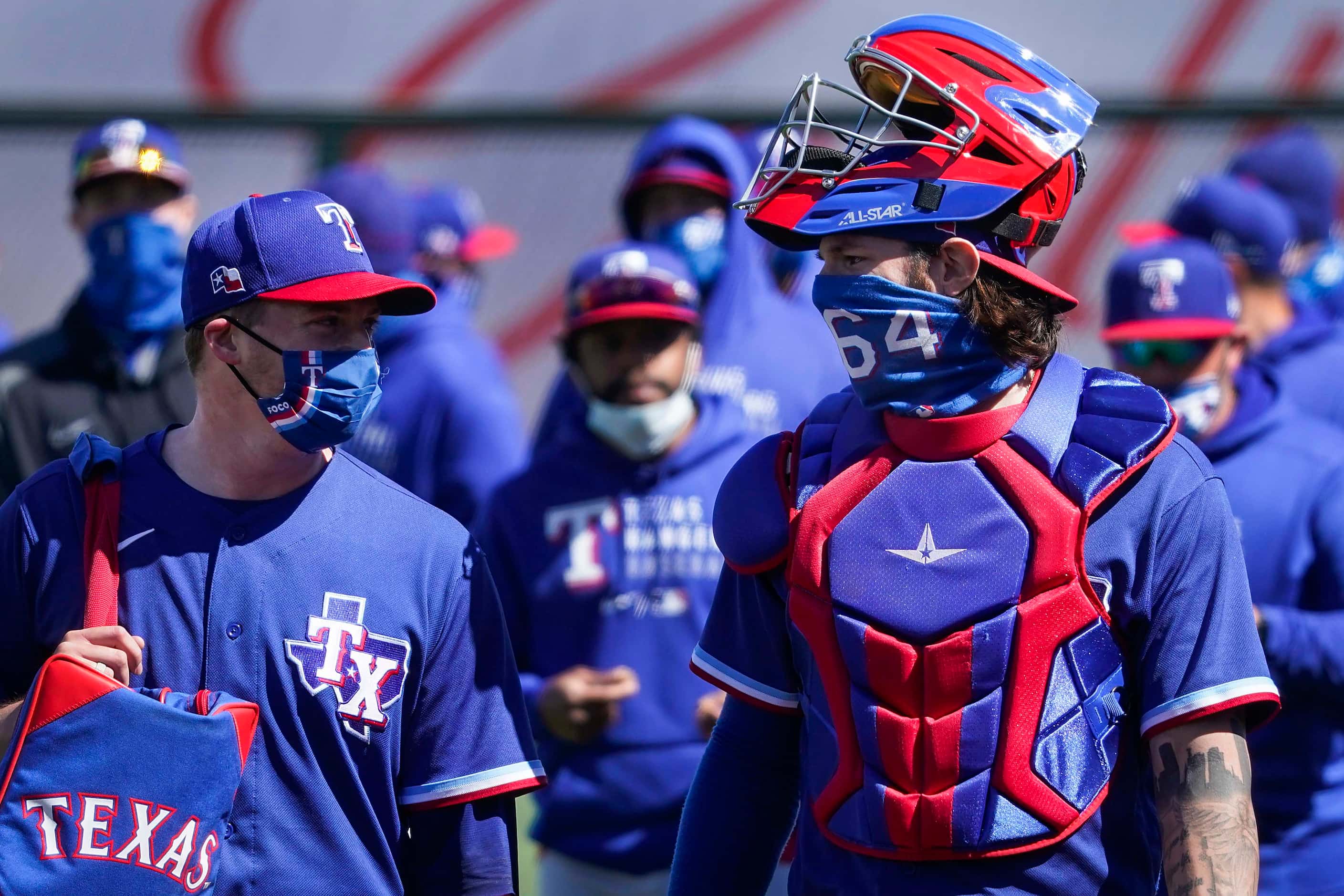 Texas Rangers starting pitcher Wes Benjamin takes the field with catcher Jonah Heim before...