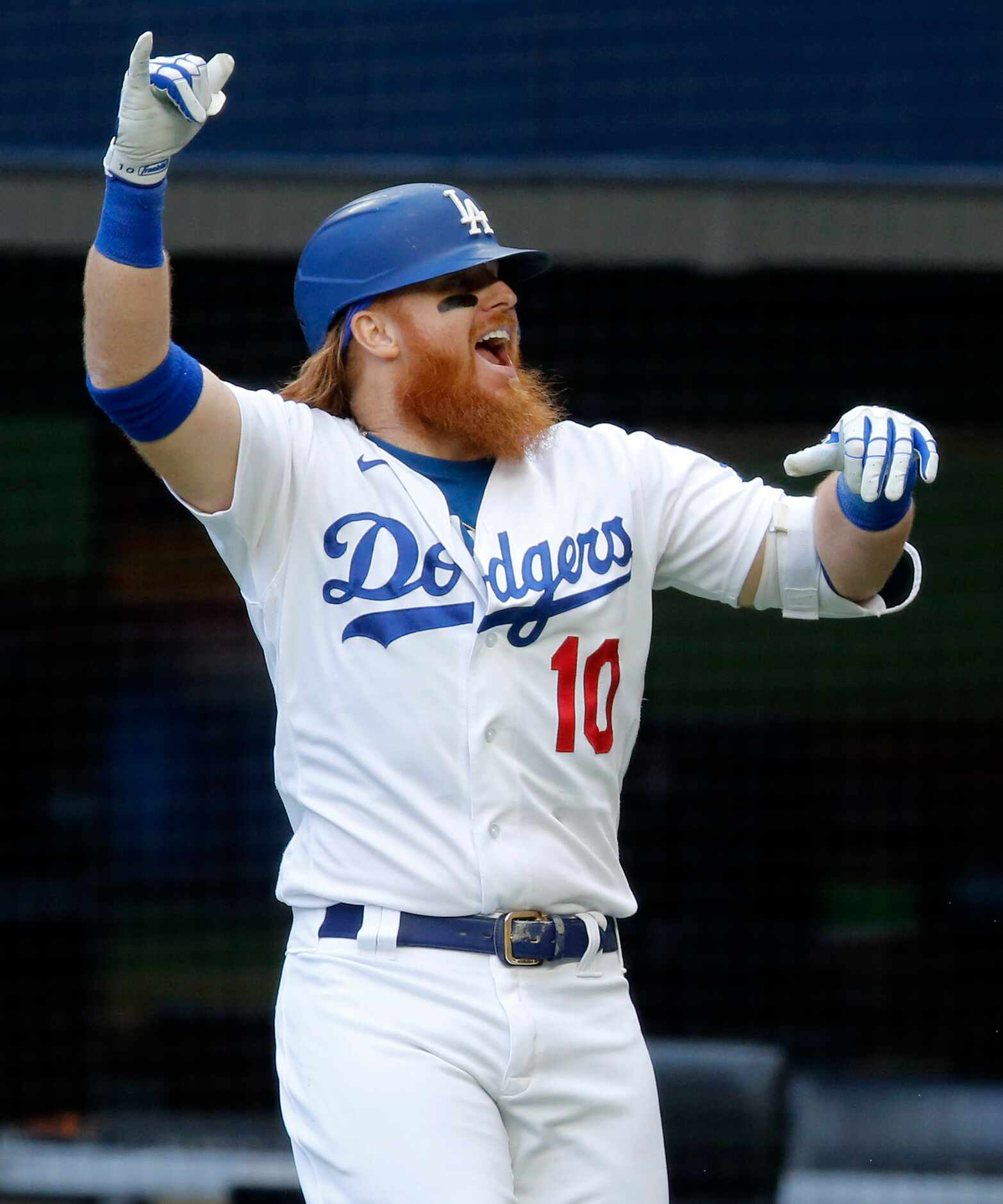 Los Angeles Dodgers Justin Turner (10) celebrates his first inning solo home against the...