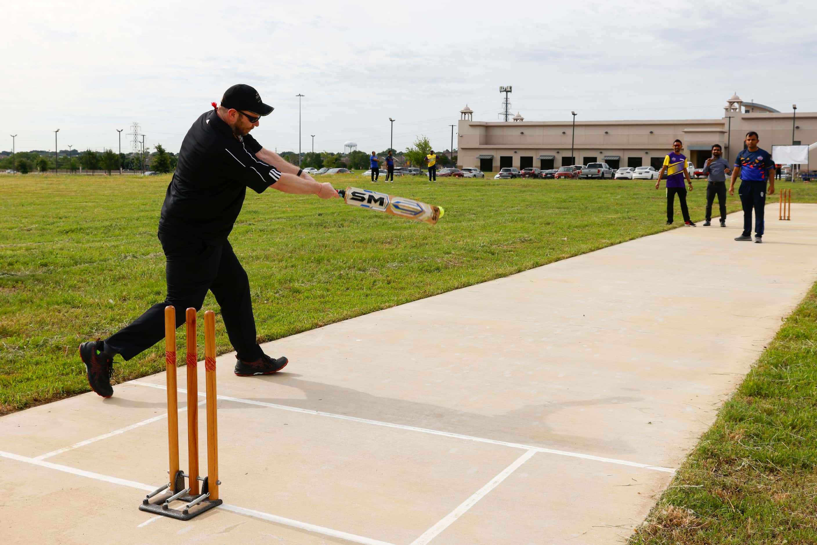Irving city council member Brad LaMorgese, bats during a ceremonial cricket game ahead of a...