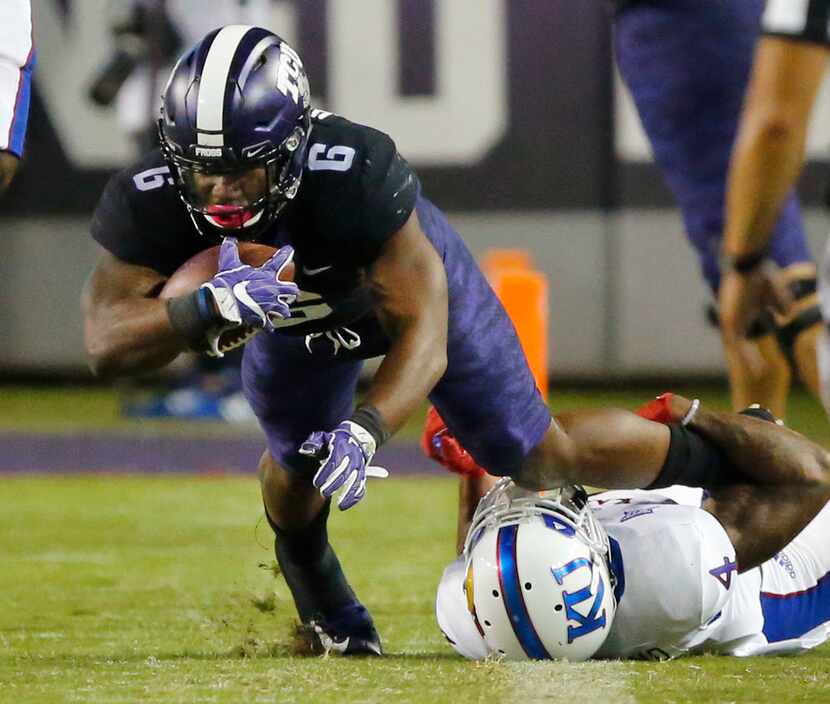 TCU Horned Frogs running back Darius Anderson (6) is tackled along the sideline by Kansas...