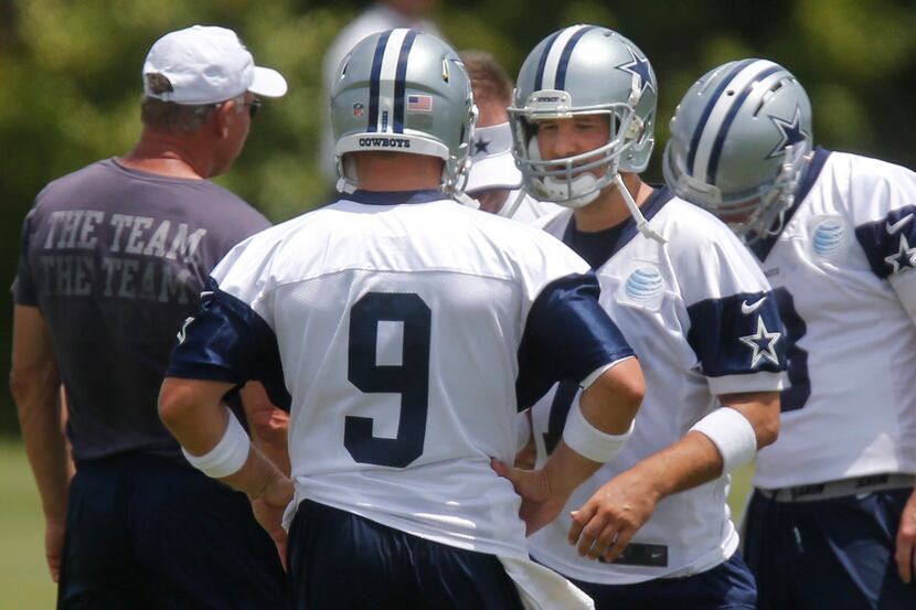 Dallas quarterback Tony Romo, facing camera, smiles after trading jerseys with quarterback...