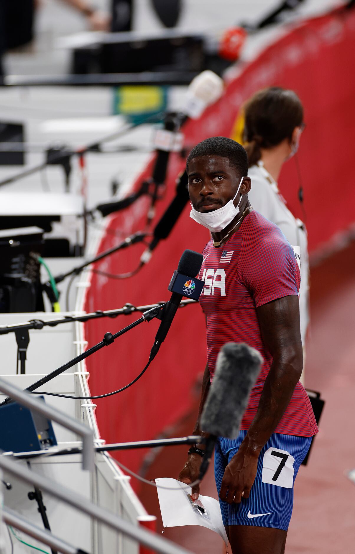 USA’s Trayvon Bromell watches the replay of his race before answering questions from the...