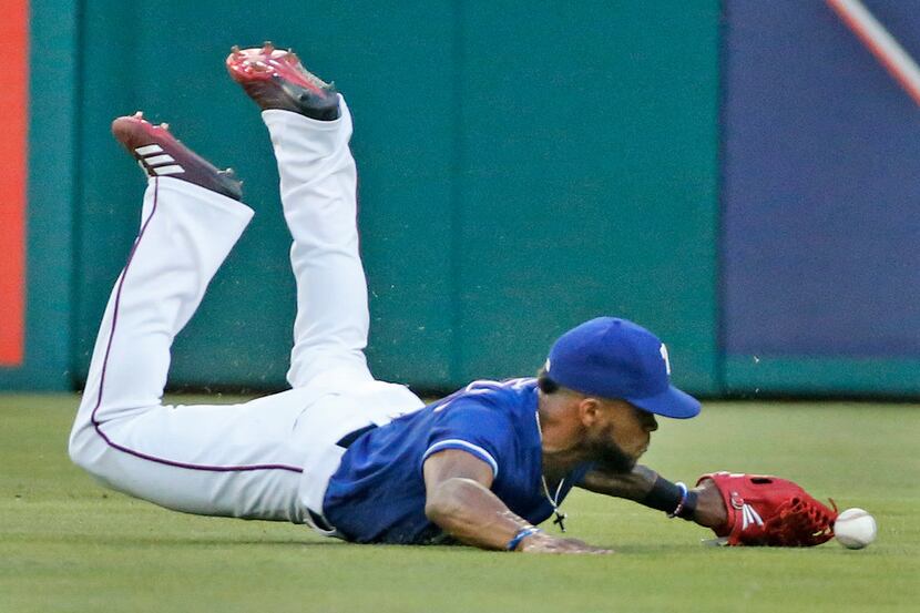 Texas Rangers center fielder Delino DeShields (3) dives but can't quite get Gary Sanchez's...