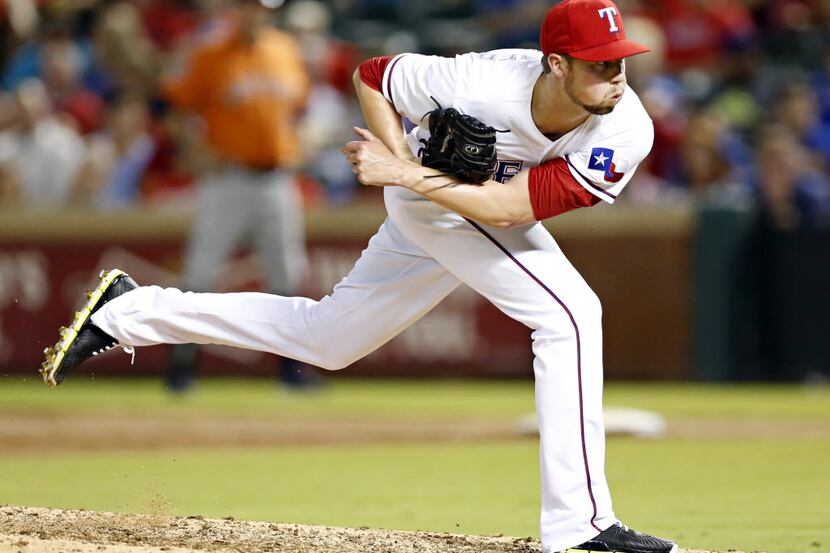 Texas Rangers relief pitcher Andrew Faulkner throws during the eighth inning of Texas' 14-3...