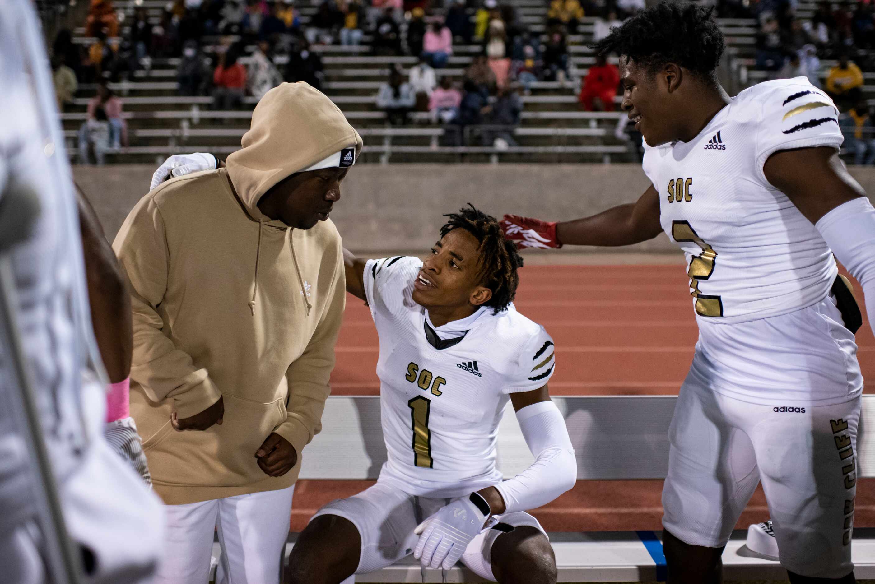 South Oak Cliff junior Manny Muhammad (1) sits down with his team after intercepting a pass...