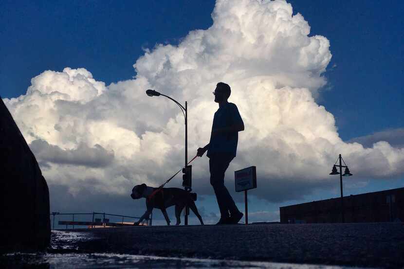 Rain clouds billowed over downtown Dallas, which could see four straight days of rain...