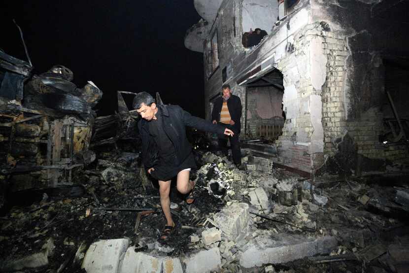 Civilians search for survivors in the rubble at the scene of a car bomb attack near the city...