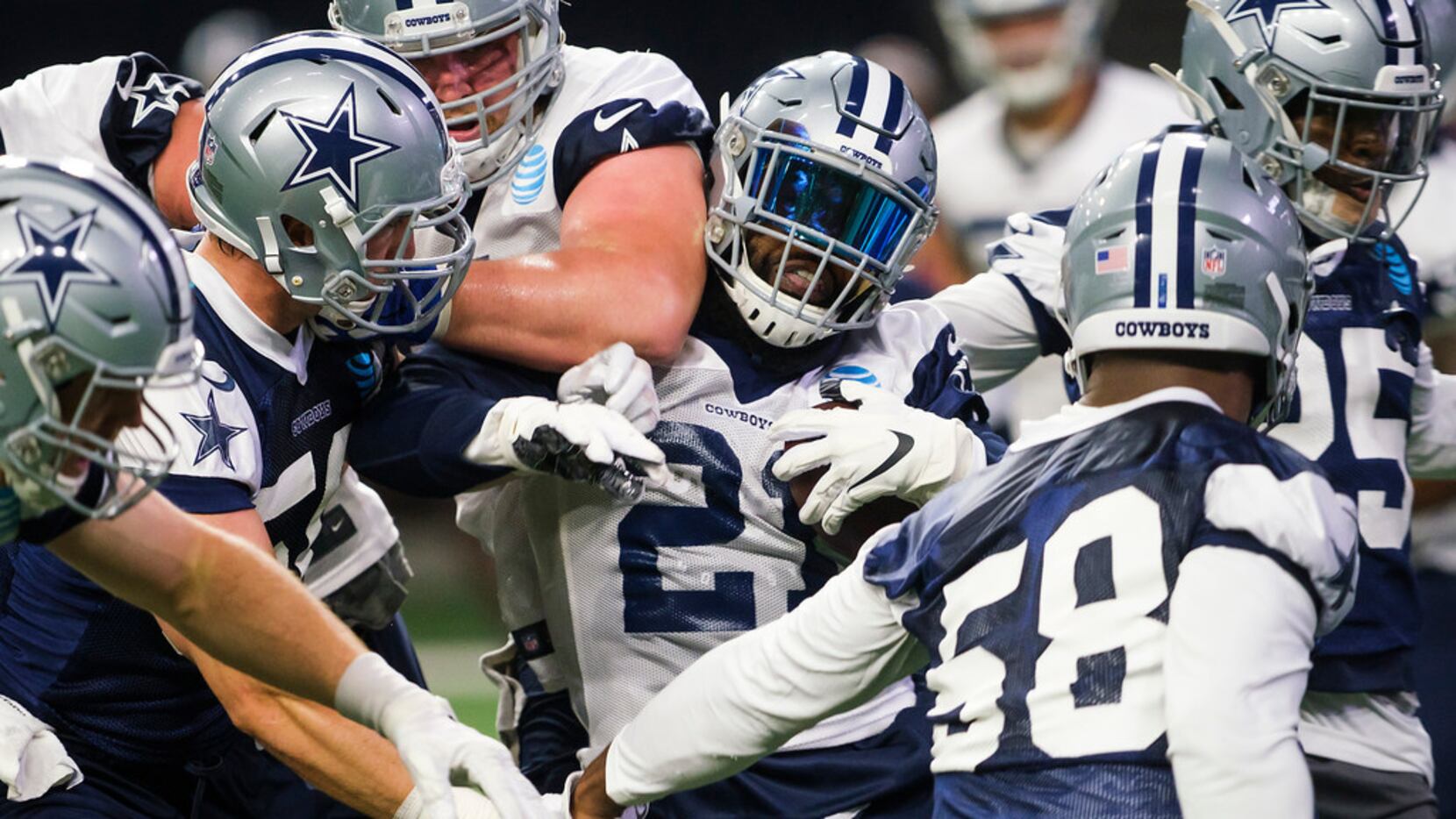 Dallas Cowboys running back Ezekiel Elliott (21) fights for yards in traffic during a team...