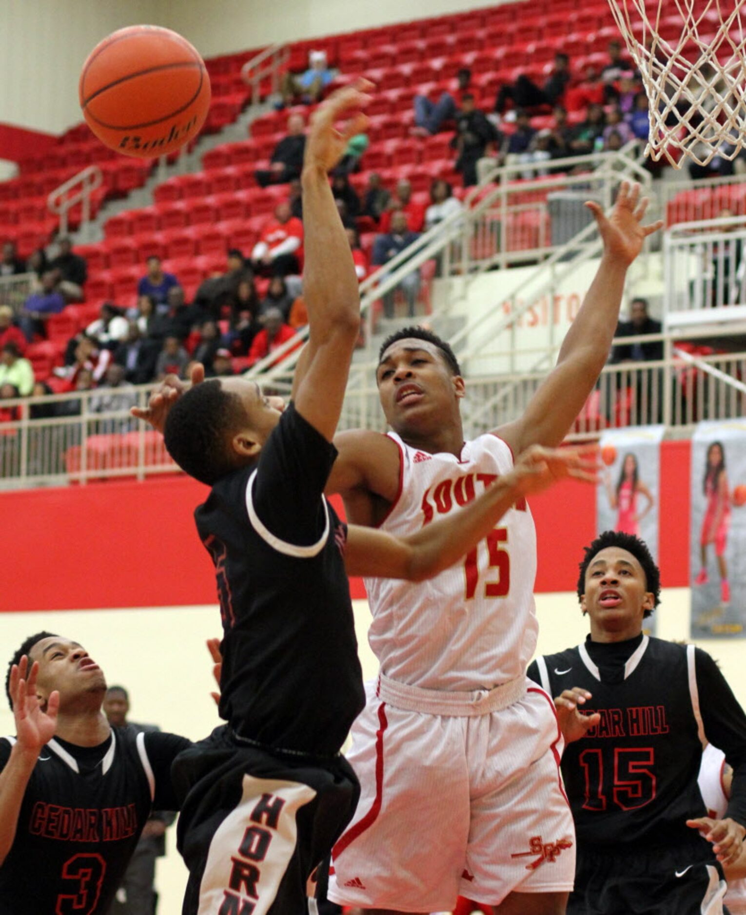 South Grand Prairie guard Jordan Horton (15) goes up to block a shot by Cedar Hill guard...