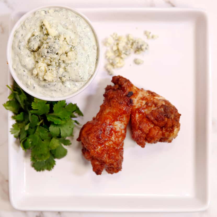 Cilantro Blue Cheese dip with cilantro, blue cheese, sour cream and mayo is served with...