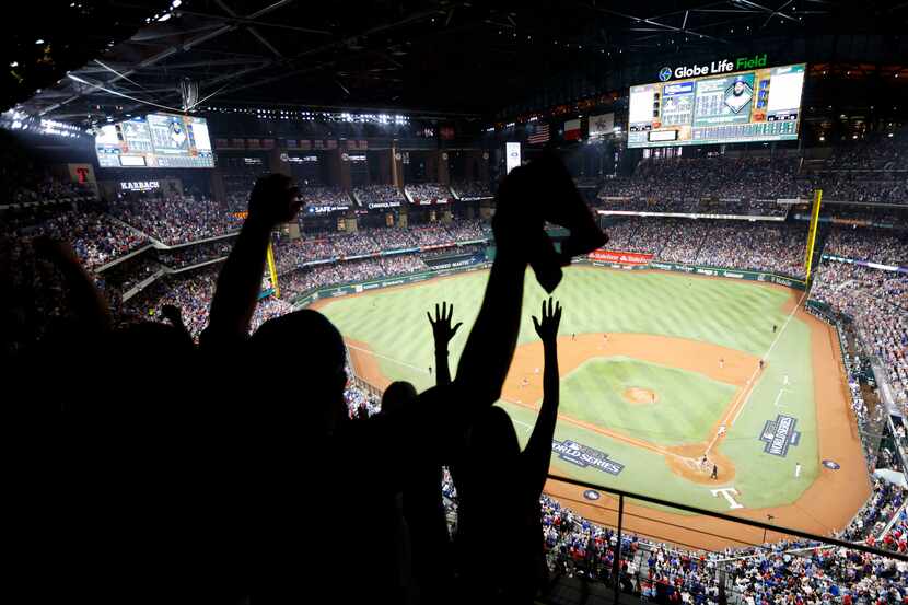 Crowd cheer as Texas Rangers Adolis Garcia takes a single during the first inning of game 1...