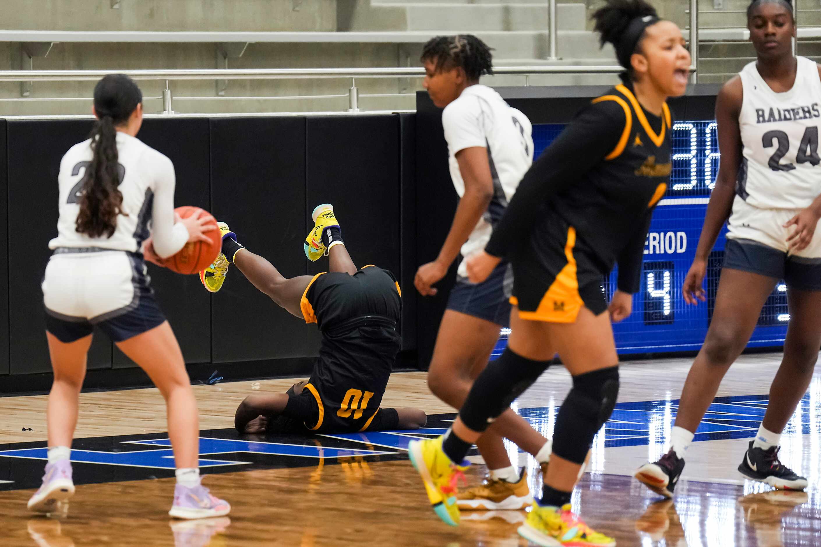 Frisco Memorial's Jasmyn Lott (10) takes a tumble after hitting a shot during a Class 5A...