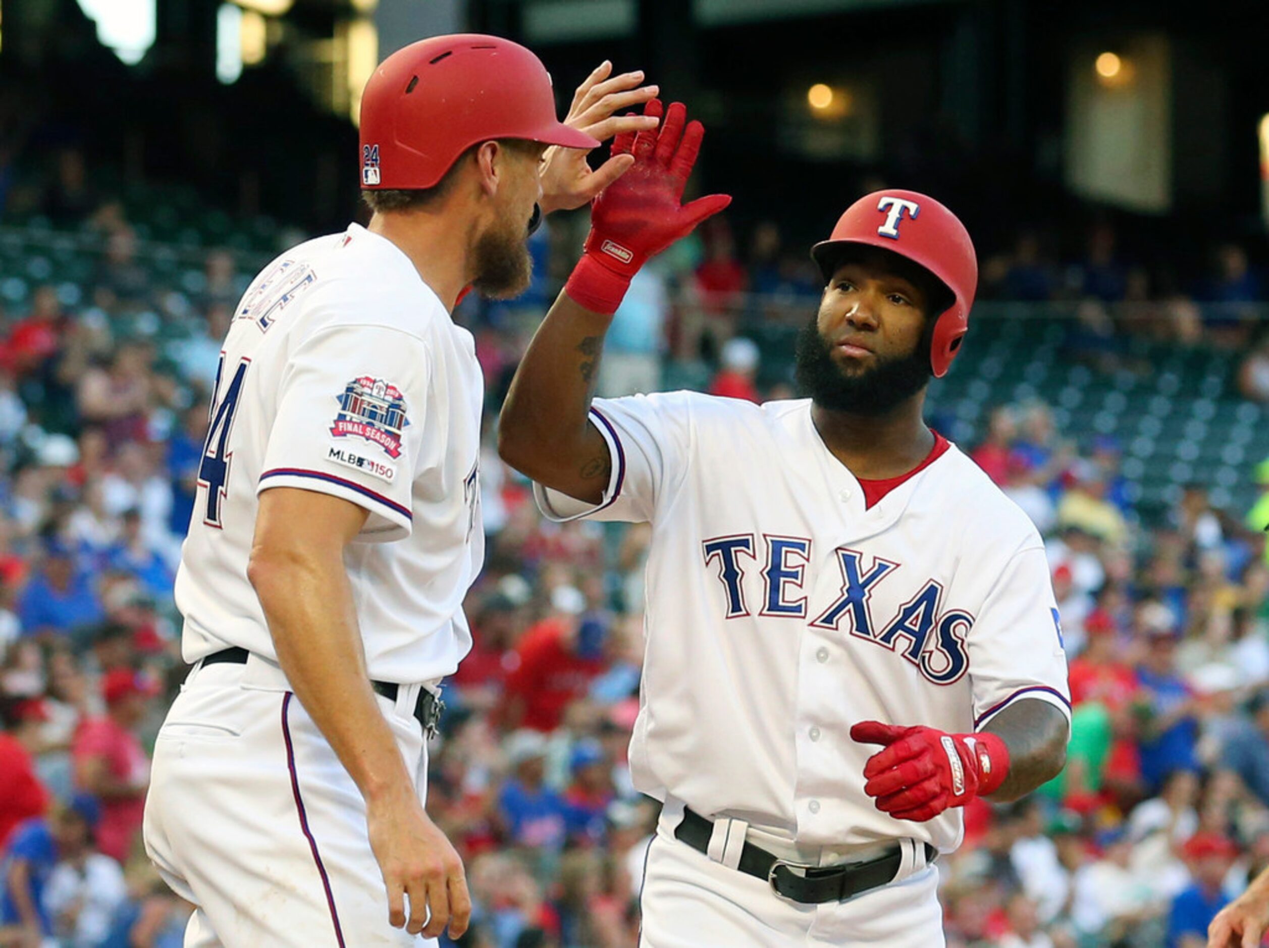 Texas Rangers Hunter Pence (24) greets Danny Santana (38) after Santana's two-run home run...