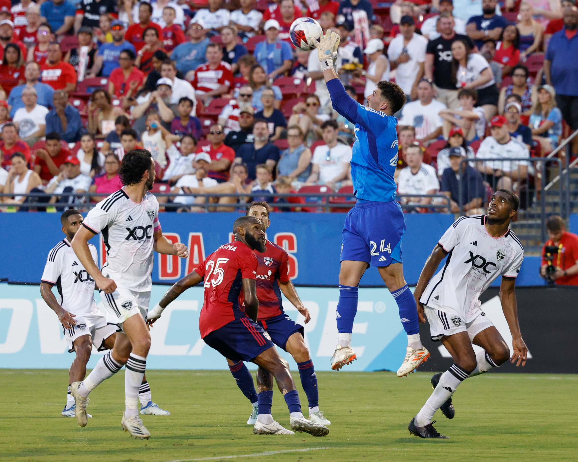 D.C. United goalkeeper Alex Bono (24) jumps to secure the ball over FC Dallas defender...