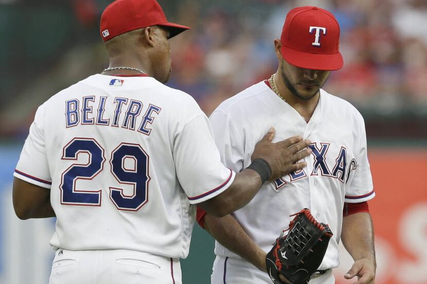 Texas Rangers third baseman Adrian Beltre (29) tries to calm Texas Rangers starting pitcher...
