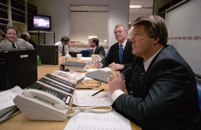 Jimmy Johnson, right, sits with team owner Jerry Jones, second from right, in a calm and...