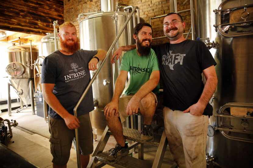 Intrinsic Smokehouse & Brewery owner Cary Hodson (center), his brother-in-law and business...
