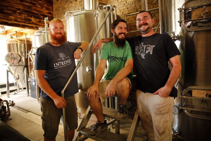 Intrinsic Smokehouse & Brewery owner Cary Hodson (center), his brother-in-law and business...
