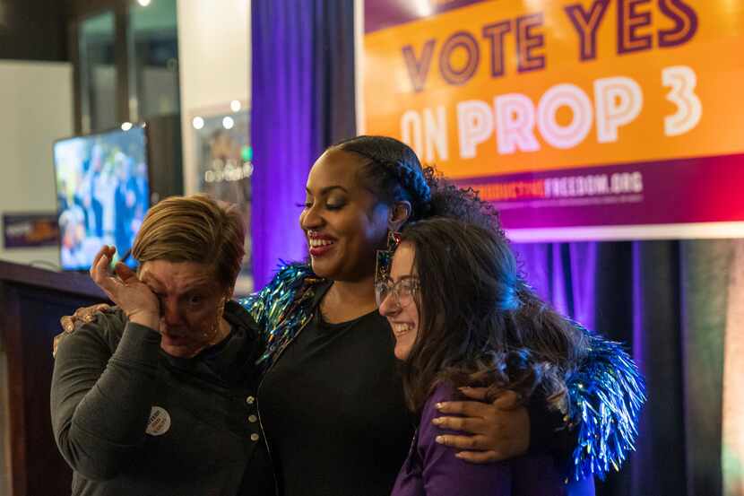Supporters react as preliminary results come in for Michigan Proposal 3 on Election Day,...