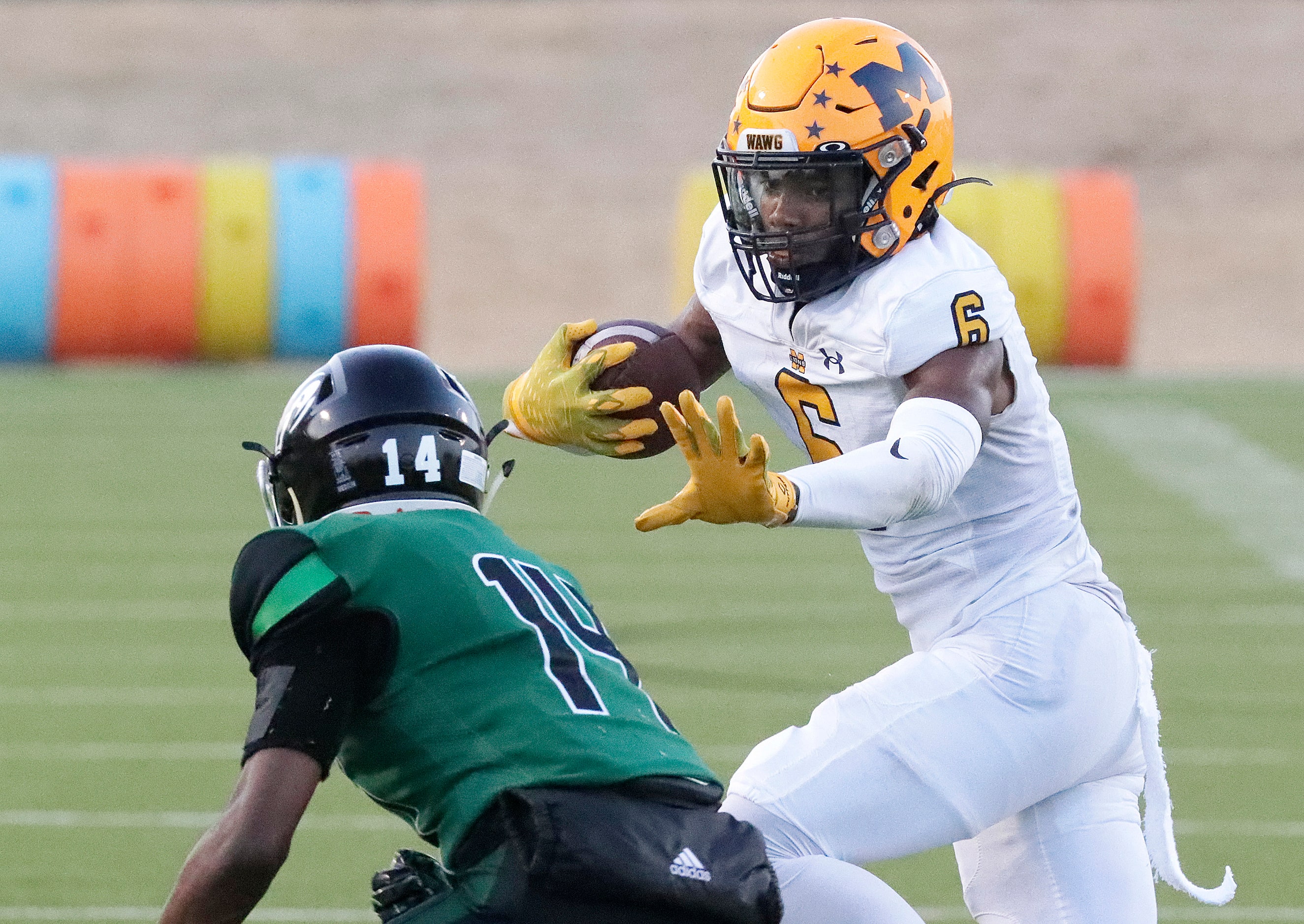 McKinney High School wide receiver Sincere Blakely (6) prepares to stiff arm Berkner High...