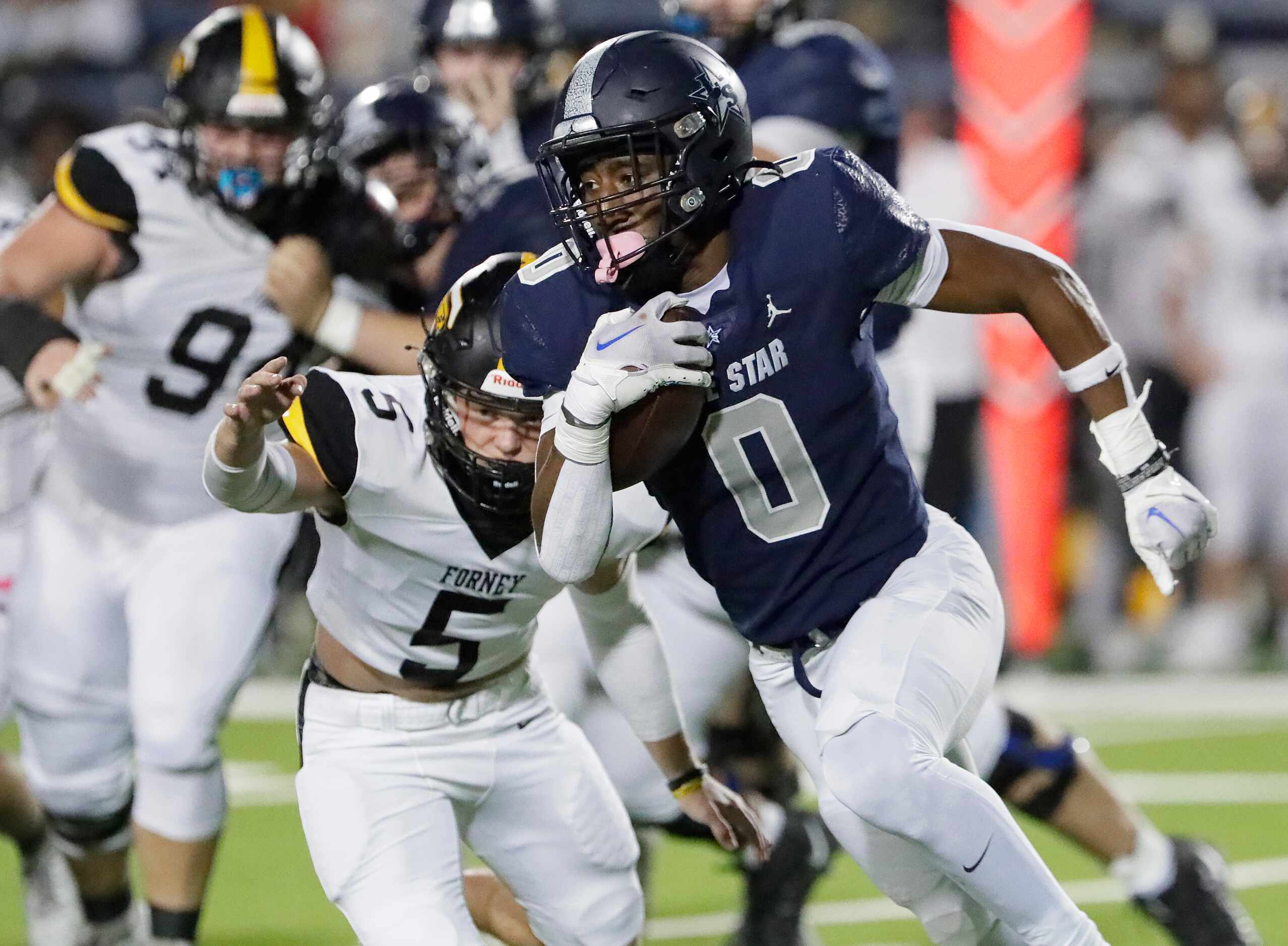 Forney High School outside linebacker Easton McMillan (5) attempts to tackle Lone Star High...