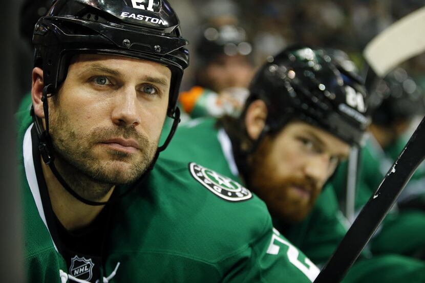 Dallas Stars defenseman Aaron Rome watches the action from the bench during their game with...