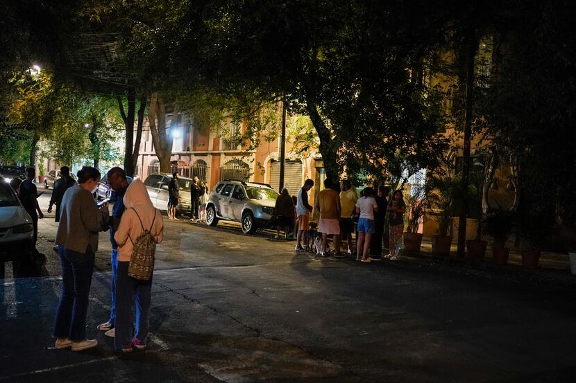 People gather outside after an earthquake was felt in Mexico City, Thursday, Sept. 22, 2022....
