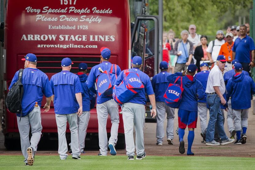 Texas Rangers player head to the buses after a 7-5- victory over the San Francisco Giants in...