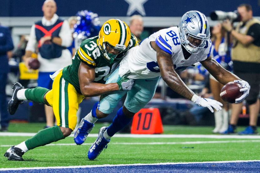 Dallas Cowboys wide receiver Dez Bryant (88) dives over the goal line for a touchdown while...