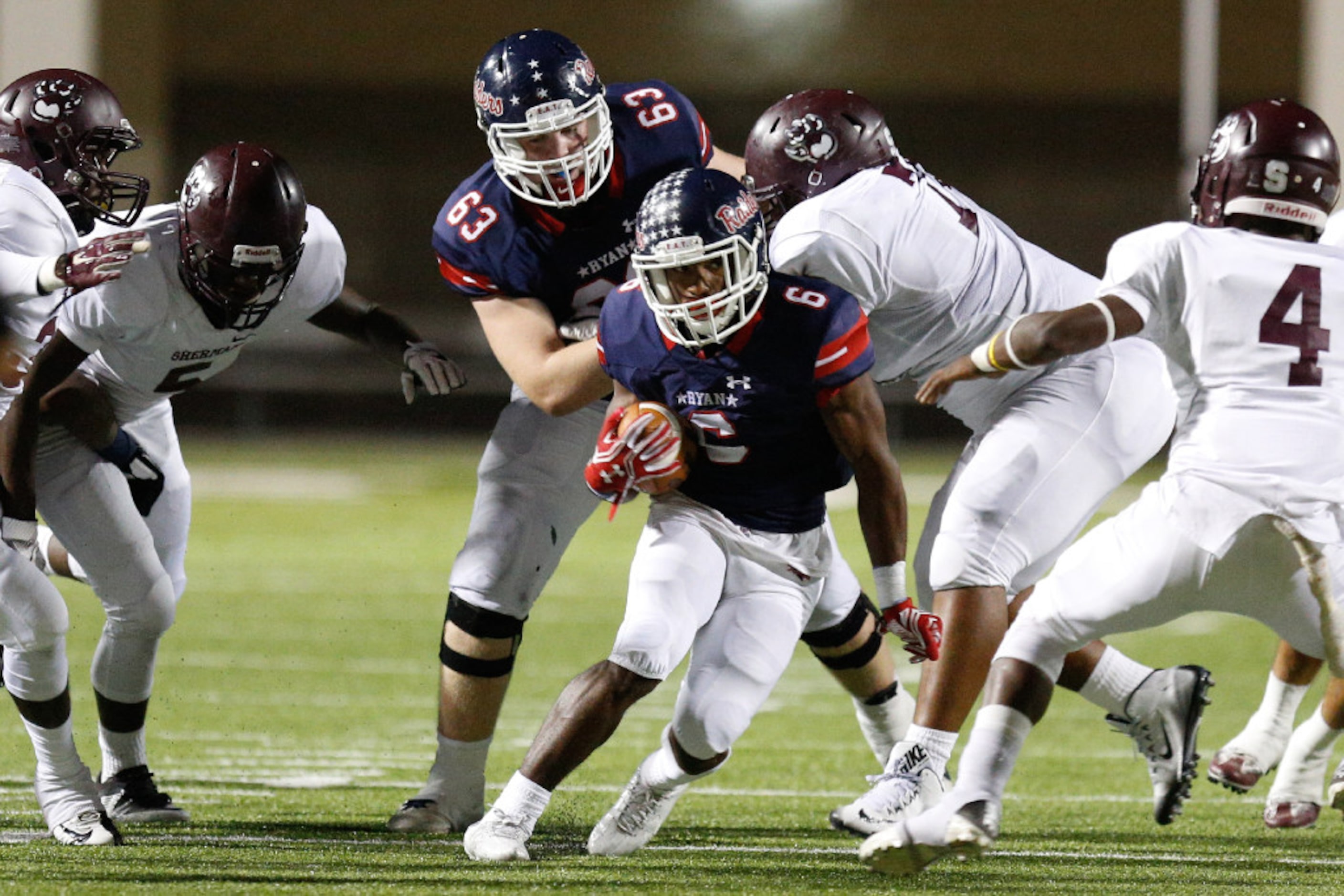 Ryan junior running back Tamar Butts (6) finds a hole and runs the ball through the Sherman...