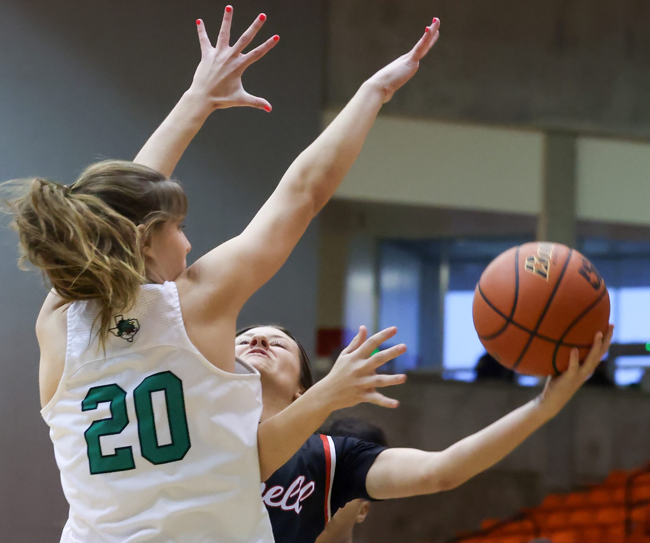 Southlake Carroll senior guard Camryn Tade (20) jumps to block Coppell senior guard Macey...