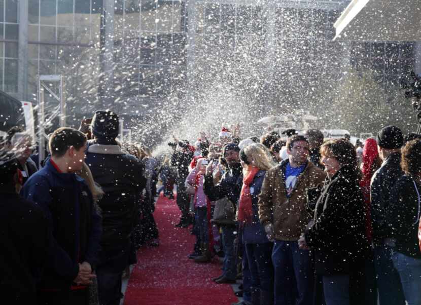 Hundreds of volunteers wait on the red carpet for 500 homeless people to arrive at the Omni...