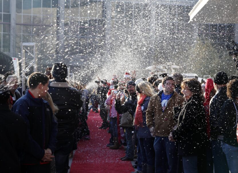 Hundreds of volunteers wait on the red carpet for 500 homeless people to arrive at the Omni...