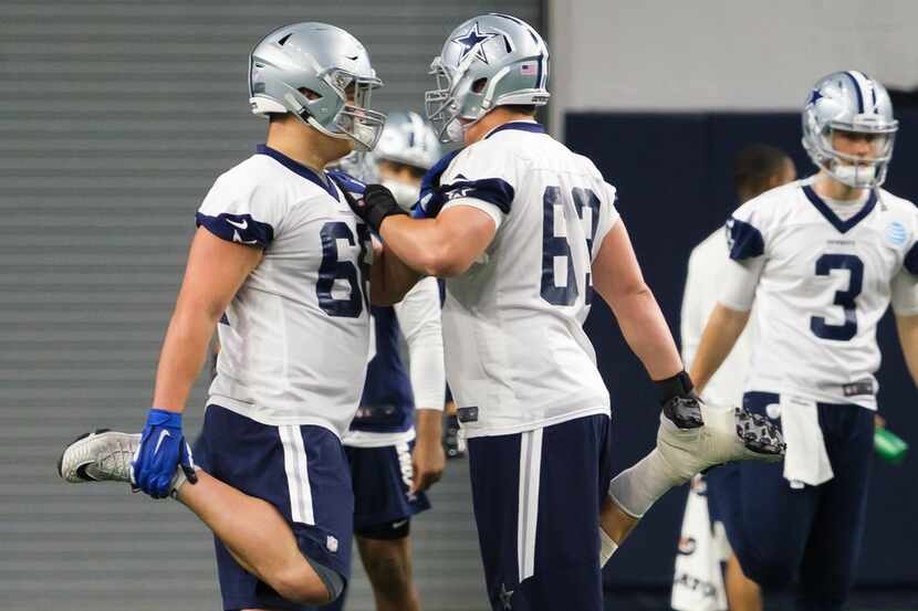 Dallas Cowboys offensive lineman Connor McGovern (66) stretches with offensive tackle Jake...