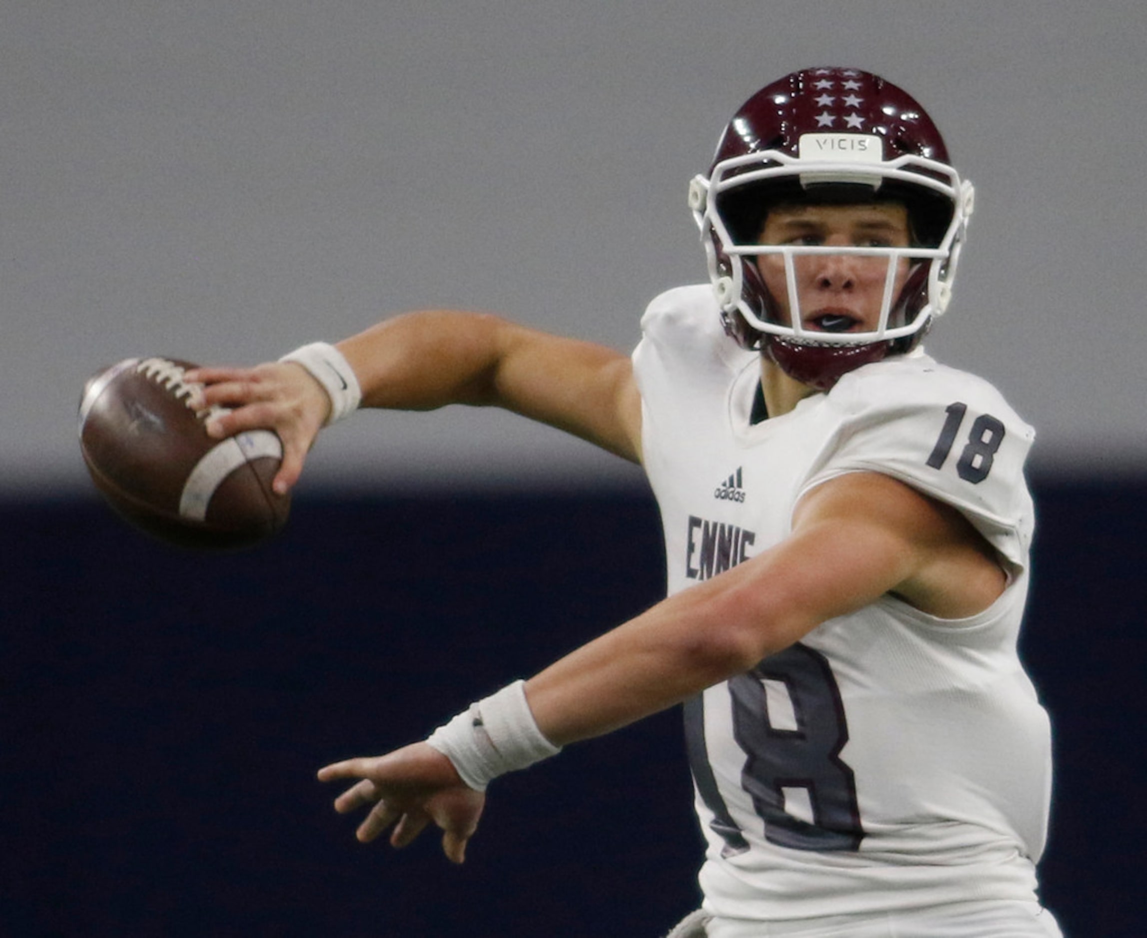 Ennis quarterback Collin Drake (18) looks to pass downfield during second quarter action...