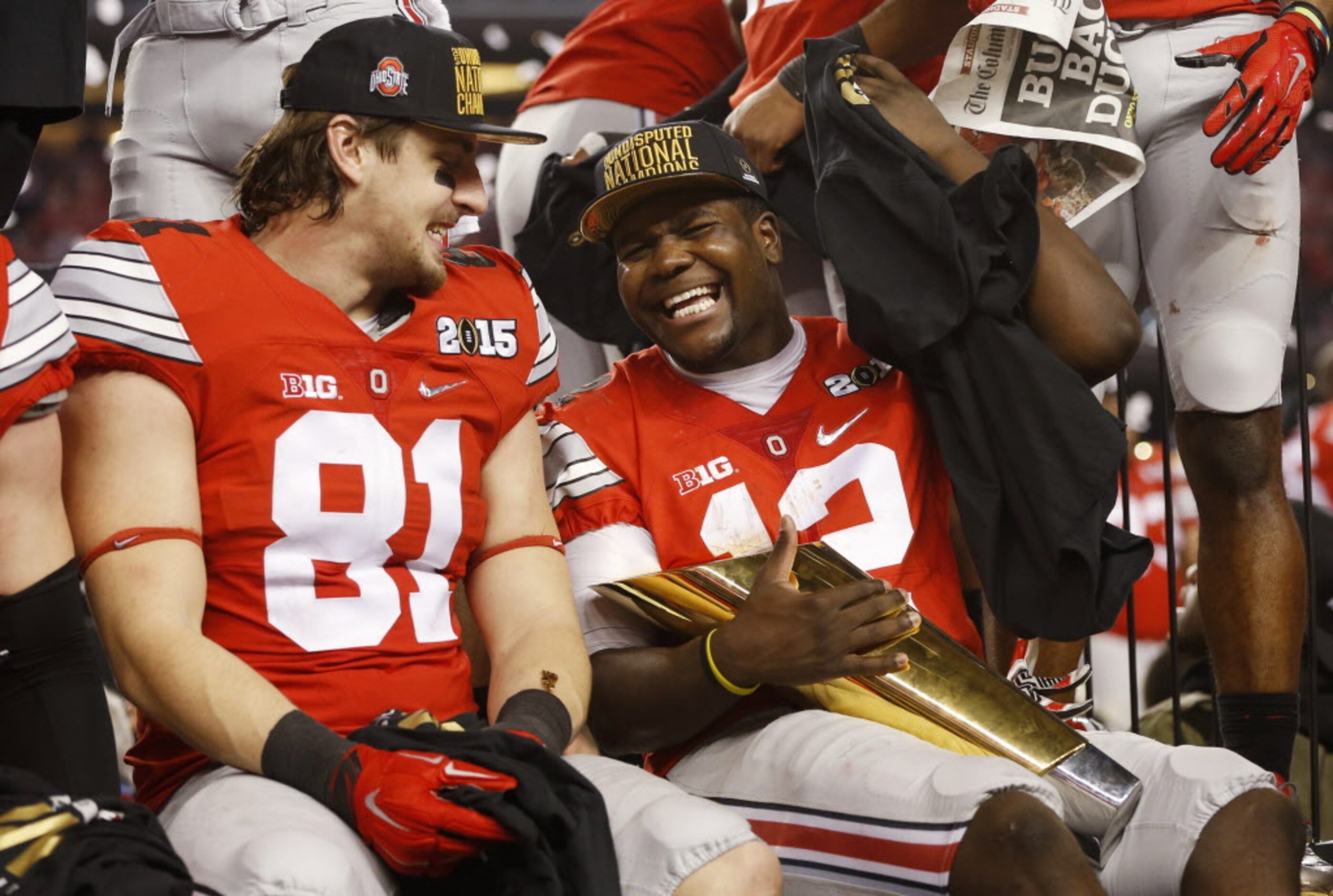 Ohio State Buckeyes quarterback Cardale Jones (12) shares a laugh with Oregon Ducks tight...