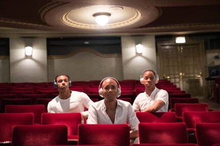 Dancers Kimara Wood (left), Sean J. Smith and Claude Alexander III don headphones that...