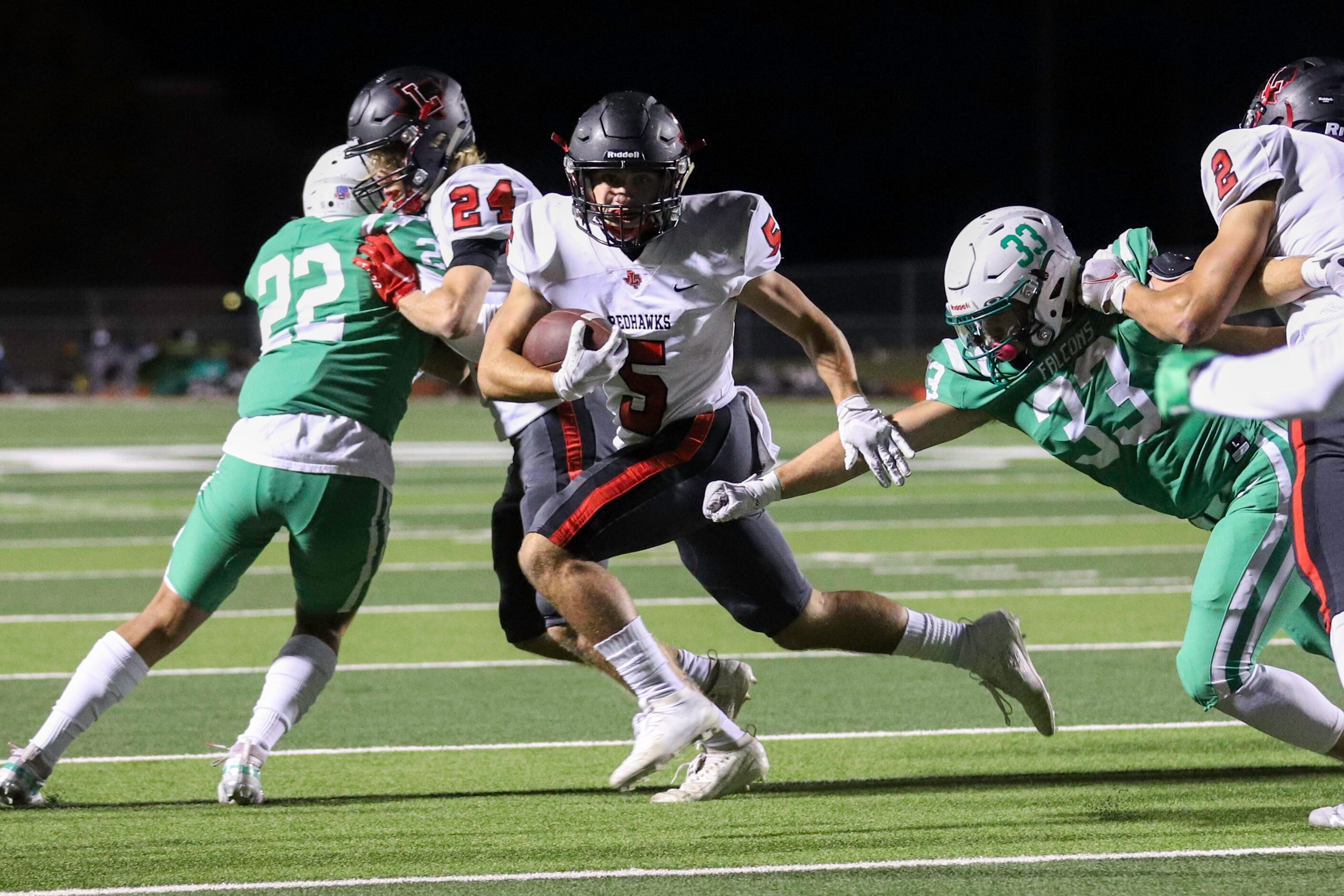 Lake Dallas linebacker Patrick Wenger (33) tries to bring down Frisco Liberty running back...