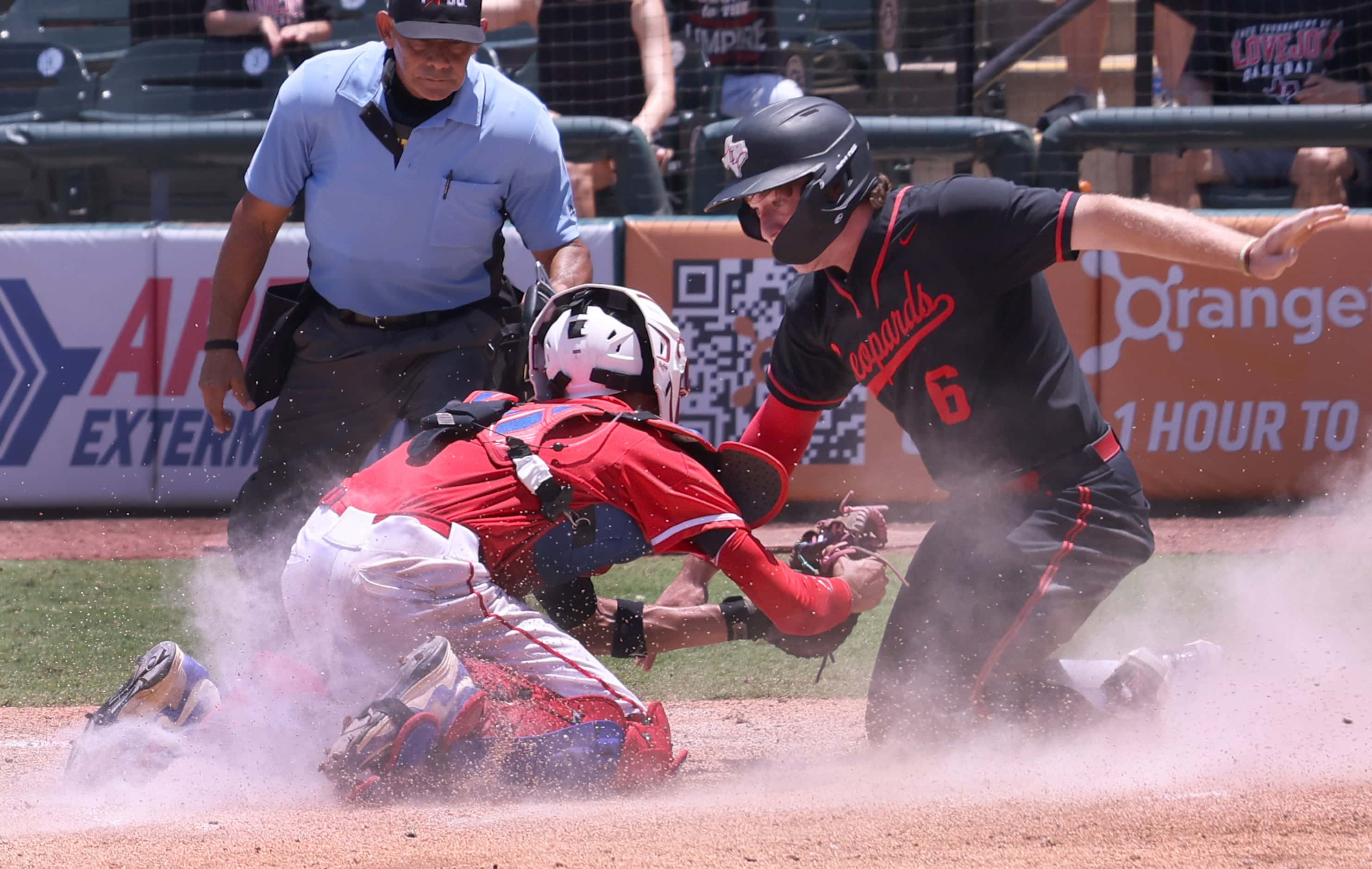 Lovejoy designated hitter Asher Lacy (6), right, is tagged out at the plate by Grapevine...