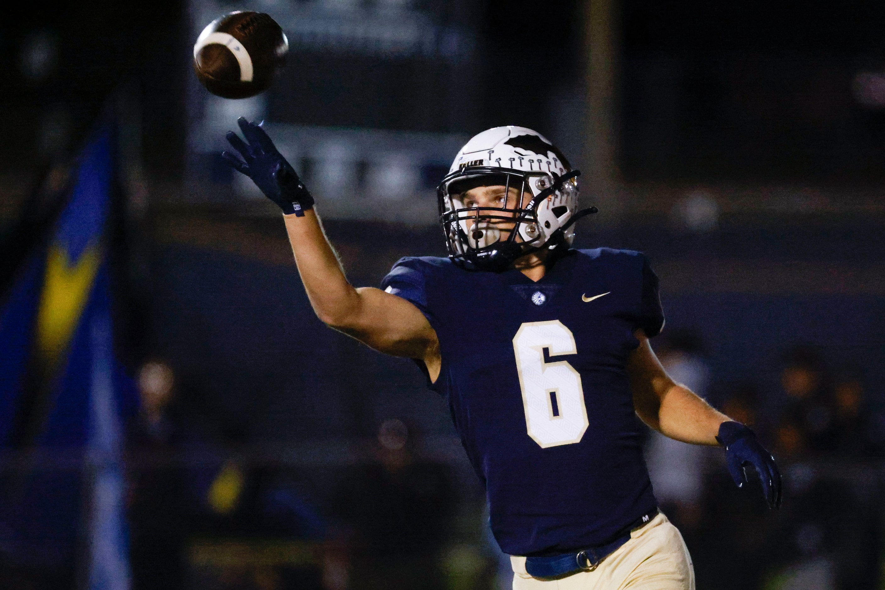 Keller High school’s Drew Roberts (6) hands off the ball after scoring a touchdown against...