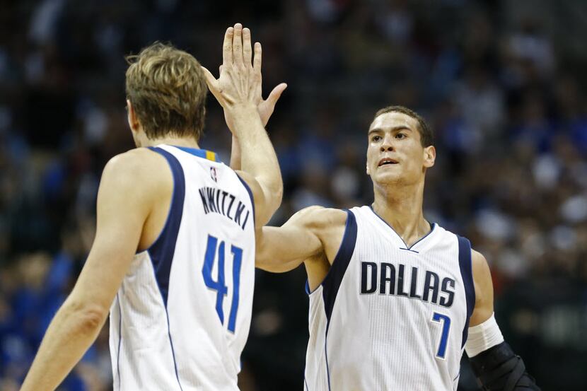 Dirk Nowitzki  and Dwight Powell celebrate after a shot against the Pelicans at American...
