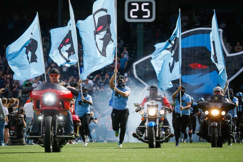 Veterans on motorcycles lead the Dallas Renegades out before an XFL football game against...