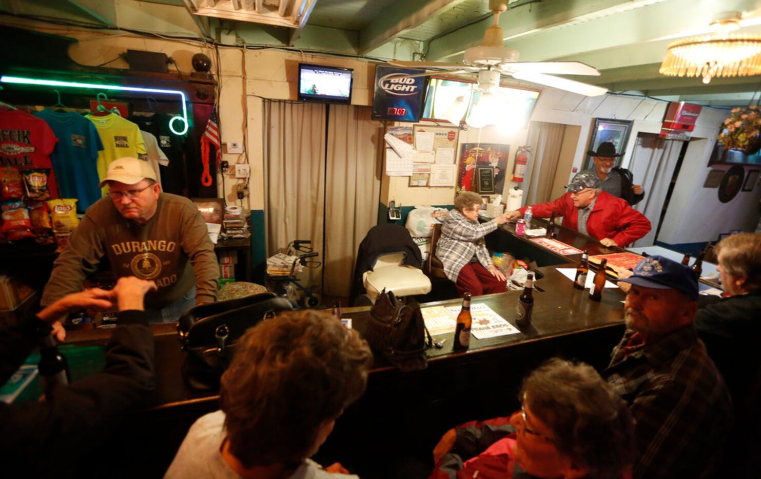 Kenny Sulak (left) and his mother, Alice Sulak, talk to customers at the downstairs bar.