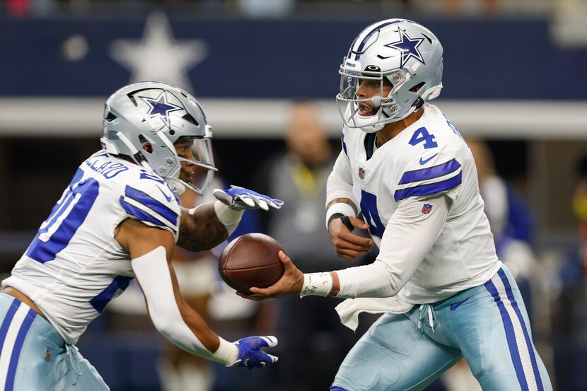 Dallas Cowboys quarterback Dak Prescott (4) hands the ball to Dallas Cowboys running back...