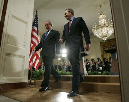 President Bush, left, and British Prime Minister Tony Blair leave a news conference in the...