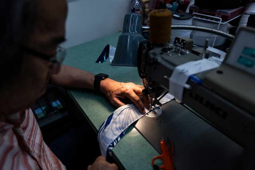 Finley Shirts sample maker Hoang Pham sews together pieces of fabric at the company’s design...