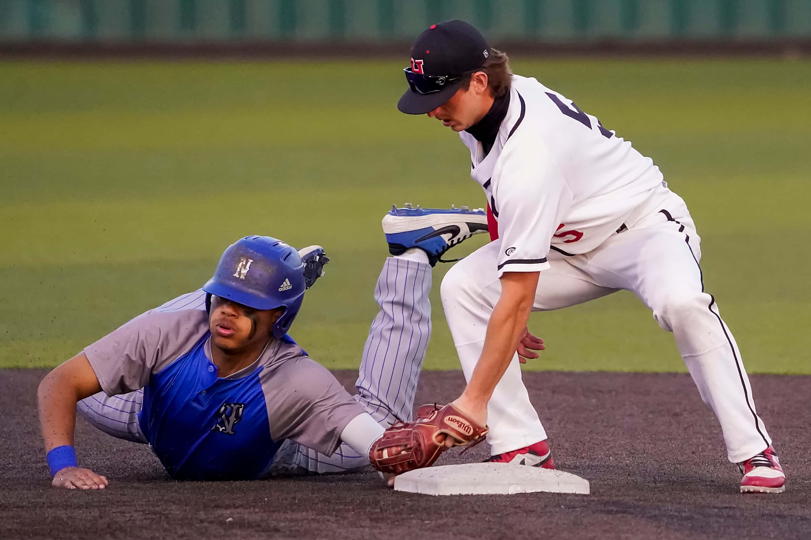 North Mesquite left fielder Kai Howard gets back to second base ahead of the tag from...