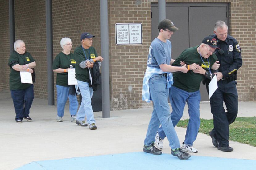 Volunteers act like victims during a recent hostage scenario simulation at Bowie Middle...